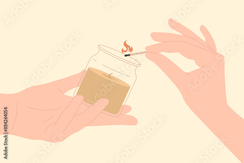 Hands holding scented candle with clear glass and match with fire to light wick. Human fingers hold wooden stick and aromatic candle jar for home spa and aromatherapy cartoon vector illustration