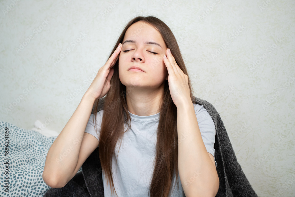 Sick teenager with cold and flu, young person with a headache, showing signs of illness. Sick teenager with cold and flu, young person with a headache, showing signs of illness.