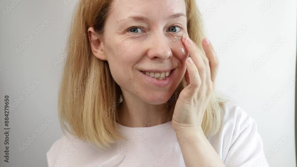 Woman putting eye patches on her face on white background, skincare product treatment, luxury facial care, glowing beauty routine Woman putting eye patches on her face on white background, skincare product treatment, luxury facial care, glowing beauty routine