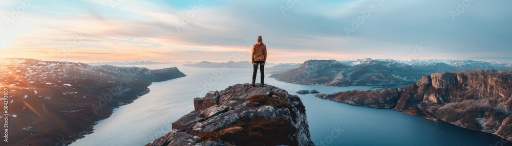 Stunning View from the Summit A Solo Climber Conquers a Steep Cliff Face at Sunrise, Achieving a Breathtaking Perspective Over the Fjord's Serenity, as Golden Light Bathes the Landscape, Marking a Stunning View from the Summit A Solo Climber Conquers a Steep Cliff Face at Sunrise, Achieving a Breathtaking Perspective Over the Fjord's Serenity, as Golden Light Bathes the Landscape, Marking a