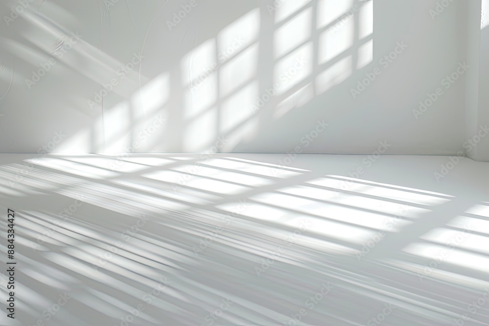 Naklejka premium Minimalist White Room with Window Light and Shadow Patterns