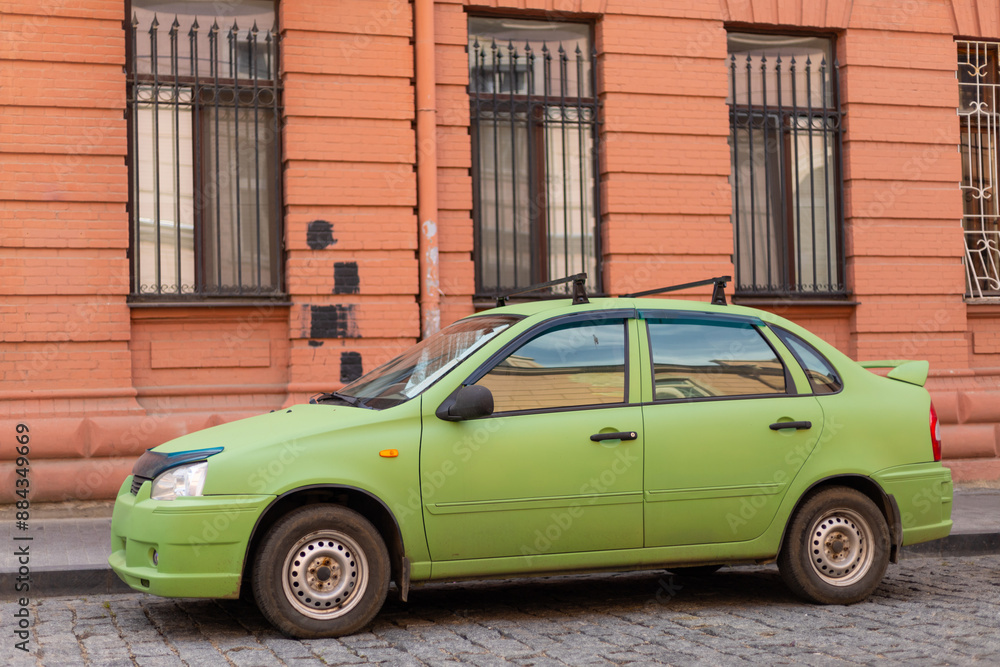 green car on the background of a brown brick wall green car on the background of a brown brick wall