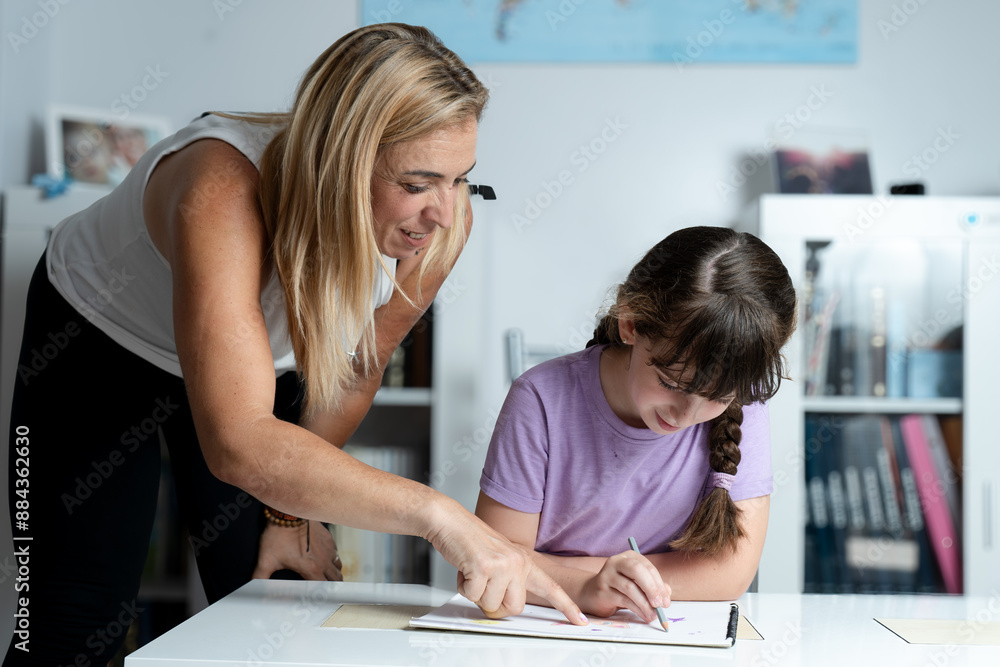 mother helping her daughter with her homework mother helping her daughter with her homework