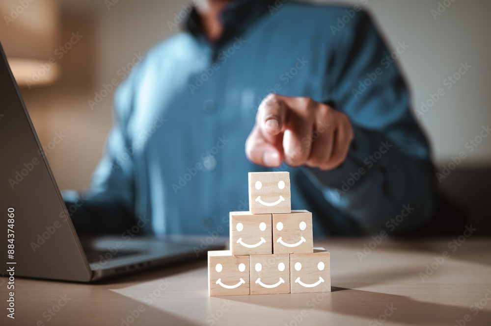 growth, cube, block, community, conceptual, employment, strategy, group, recruitment, solution. A man is pointing at a stack of wooden blocks with smiling. The blocks are arranged in a pyramid shape. growth, cube, block, community, conceptual, employment, strategy, group, recruitment, solution. A man is pointing at a stack of wooden blocks with smiling. The blocks are arranged in a pyramid shape.