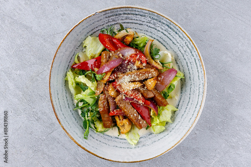 Delicious salad with veal and vegetables in beautiful dishes for the menu of a food delivery site