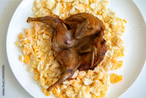 Quail prepared on a plate with pasta and egg crumbs photo