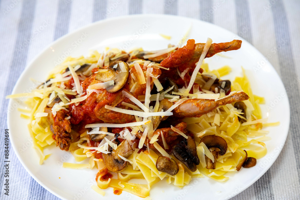Quail prepared on a plate with pasta and egg crumbs Quail prepared on a plate with pasta and egg crumbs