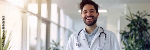 Happy doctor in white coat at modern clinic, light background