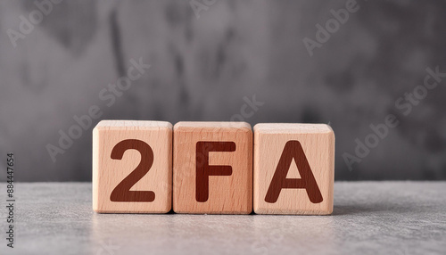 Wooden cubes with abbreviation 2FA, cement background. Two-Factor Authentication. Online security