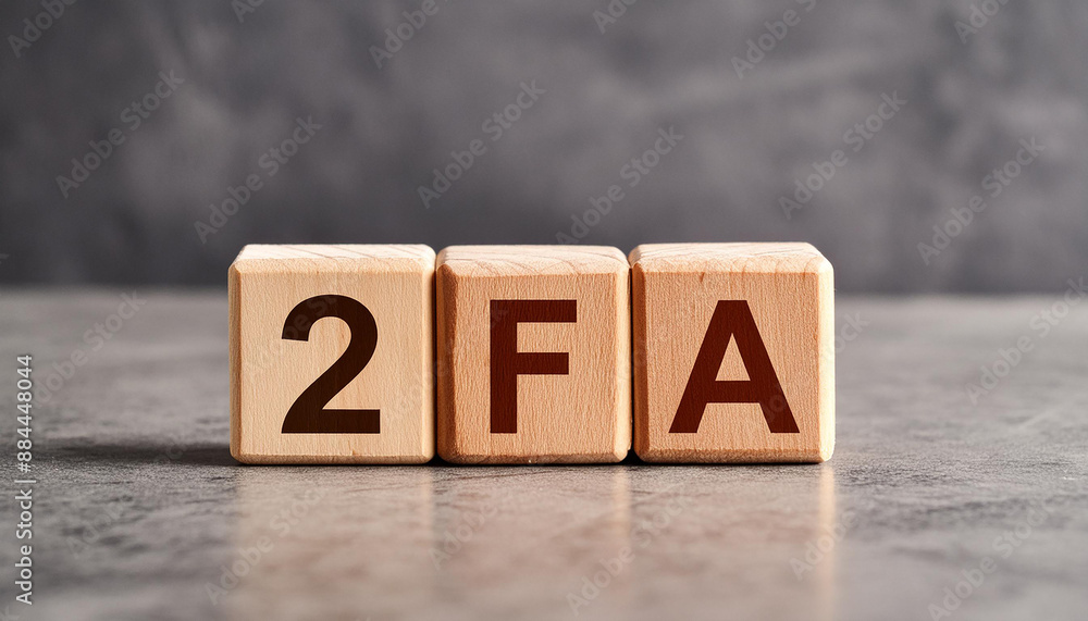Wooden cubes with abbreviation 2FA, cement background. Two-Factor Authentication. Online security Wooden cubes with abbreviation 2FA, cement background. Two-Factor Authentication. Online security
