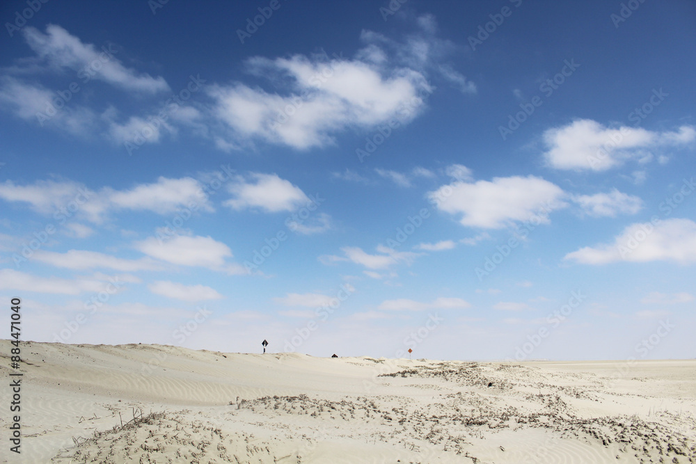Desert with sand and clear sky with clouds in the background Desert with sand and clear sky with clouds in the background