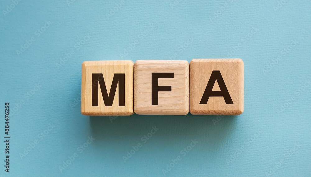 Obraz premium Wooden cubes with abbreviation MFA, blue background. Multi-Factor Authentication. Online security