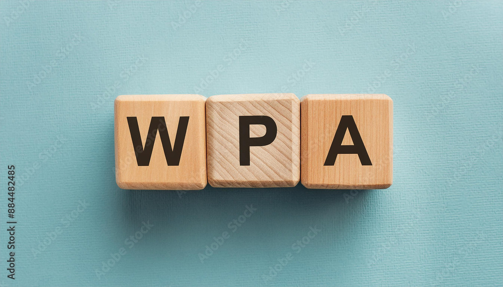 Obraz premium Wooden cubes with abbreviation WPA, blue backdrop. Wi-Fi Protected Access. Internet, online security