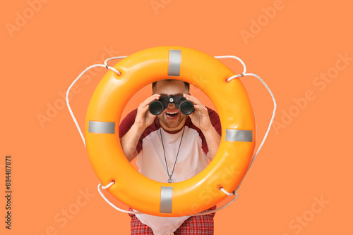 Happy young lifeguard with ...