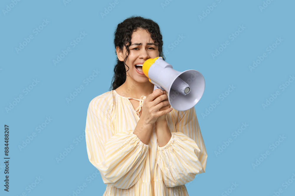 Screaming African-American woman with megaphone on blue background Screaming African-American woman with megaphone on blue background