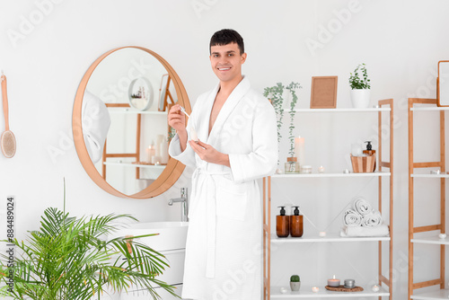 Young man with serum in bat...