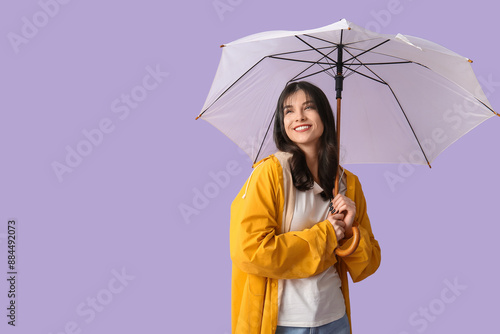Young woman in raincoat wit...