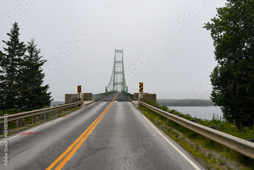 The Deer Isle Bridge in Sedgwick, Maine on a foggy morning as it spans across Eggemoggins Reach to Little Deer Isle photo