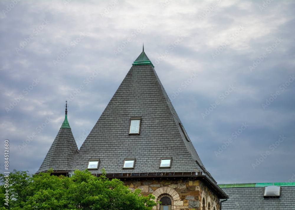 Fototapeta premium High-Pitched Roof of an old building under an overcast sky, Newton, Massachusetts, USA