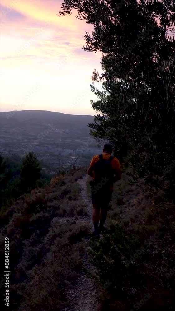 Slow motion, hiker walking in a path on a beautiful summer sunset Slow motion, hiker walking in a path on a beautiful summer sunset