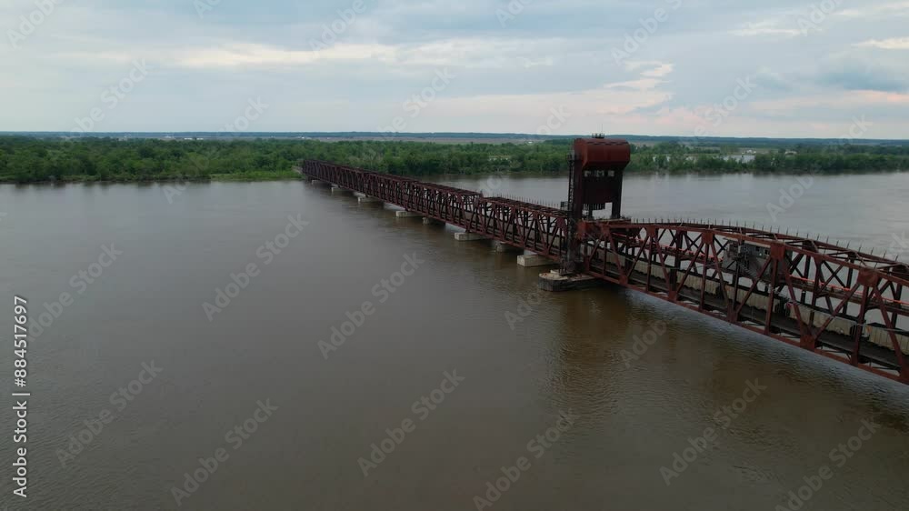 IOWA - 6.24.2024 - Great aerial view nearing a freight train as it crosses a vertical lift bridge over the Mississippi River. IOWA - 6.24.2024 - Great aerial view nearing a freight train as it crosses a vertical lift bridge over the Mississippi River.