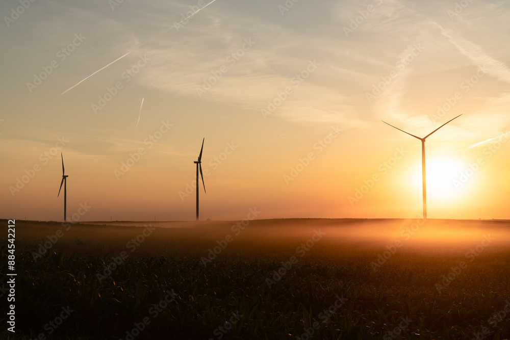 Agricultural field with wind turbines at sunset Agricultural field with wind turbines at sunset