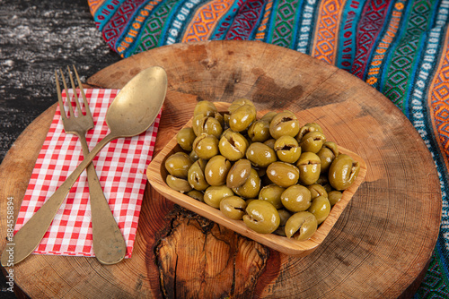 Homemade crushing olive making. Fresh green olives are breaking one by one. Crushing olives with stone. Preparing pickled olives in Turkish style. (Turkish name; kirma zeytin). Pickled Green Olives. photo