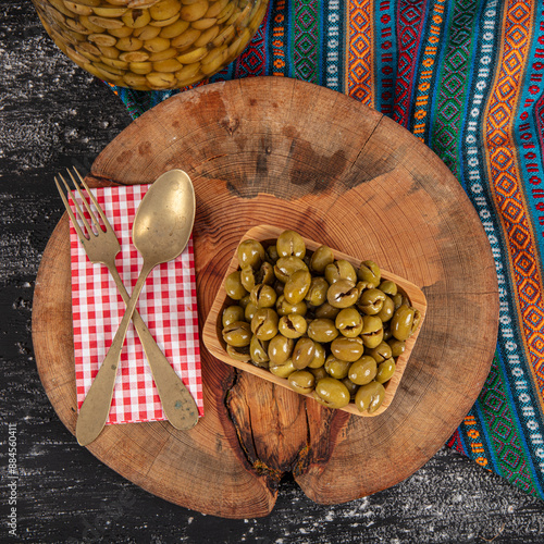 Homemade crushing olive making. Fresh green olives are breaking one by one. Crushing olives with stone. Preparing pickled olives in Turkish style. (Turkish name; kirma zeytin). Pickled Green Olives. photo