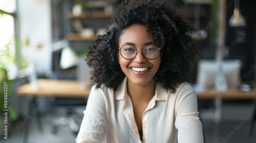 A professional image of a smiling woman with glasses at a modern office desk, illustrating focus, productivity, and an inviting workplace in a contemporary setting. A professional image of a smiling woman with glasses at a modern office desk, illustrating focus, productivity, and an inviting workplace in a contemporary setting.