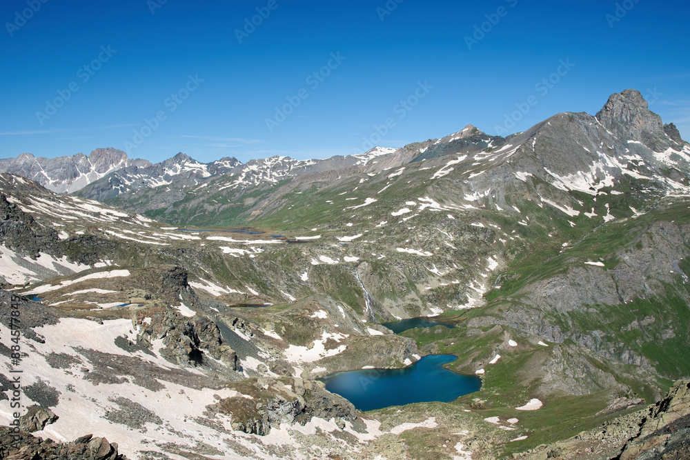 Top view of the Blue Lake and the Black Lake taken from an observation point at 2800 meters above sea level on a sunny early summer day, Chianale, Valle Varaita, Piedmont, Monviso Park, Italy.