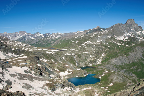 Top view of the Blue Lake and the Black Lake taken from an observation point at 2800 meters above sea level on a sunny early summer day, Chianale, Valle Varaita, Piedmont, Monviso Park, Italy. photo