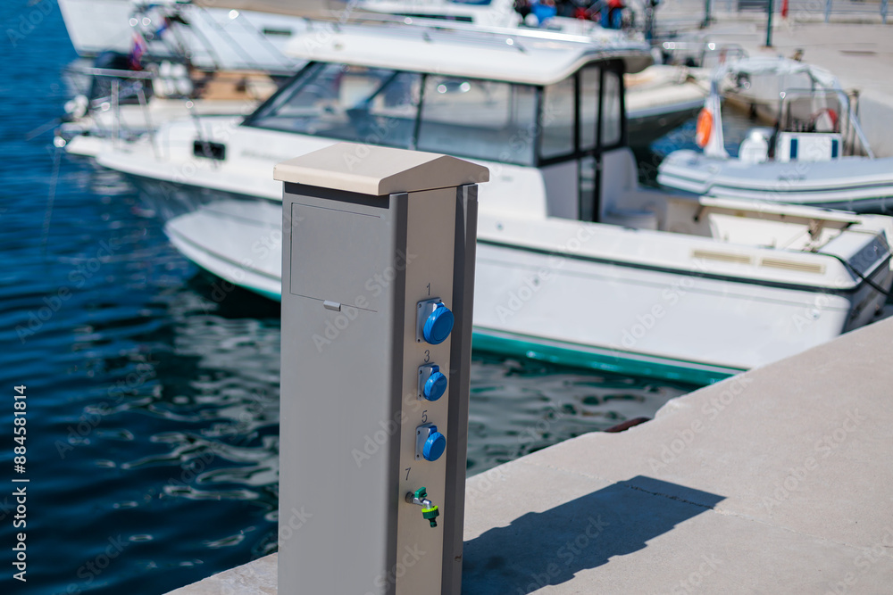 Fototapeta premium Electrical outlet and boat docked at marina