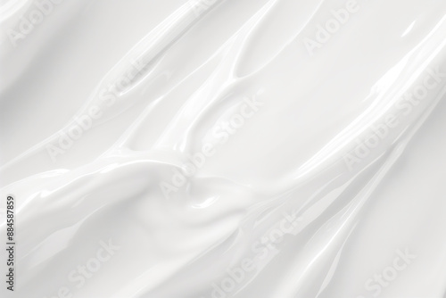 A white background with a smooth, shiny, and silky texture. The image is of a cream or lotion, which is applied to the skin. The cream is spread evenly across the surface