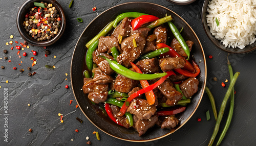 Stir frying beef with sweet peppers, green beans and rice. Top view