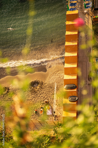 People relaxing on a beach during summer in the beach of sorrento, Italy during golden hour
