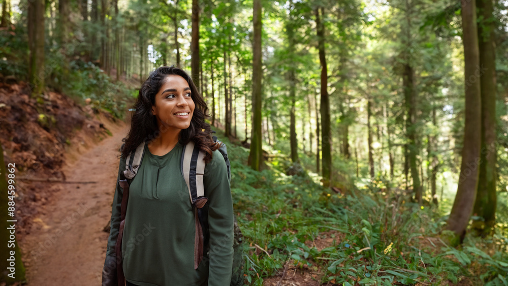 A woman is walking in a forest with a backpack on A woman is walking in a forest with a backpack on