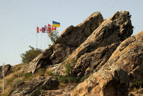 Set of sevaral flags of foreighn countries on the rock photo