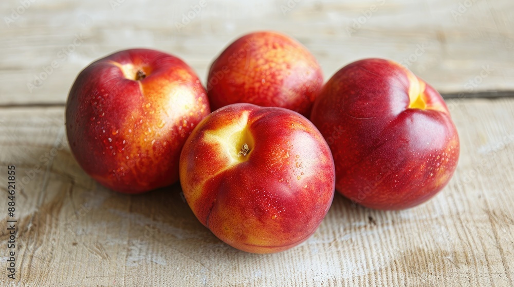 Nectarines displayed on a light colored wooden surface Nectarines displayed on a light colored wooden surface