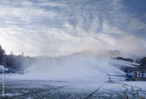 Pyeongchang-gun, Gangwon-do, South Korea - November 11, 2023: Winter and morning view of machines making spraying artificial snow on ski slope at Yongpyeong Resort 