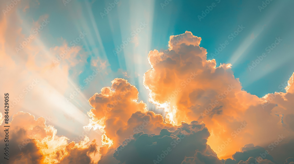 A photograph of golden sunlight breaking through fluffy clouds, beams of light radiating across a vibrant blue sky