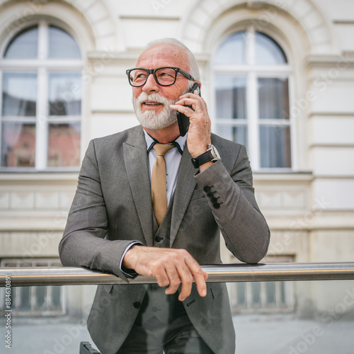 Portrait of senior man with beard businessman in suit stand outdoor