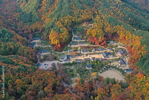 Naeji-ri, Yecheon-gun, Gyeongsangbuk-do, South Korea - October 29, 2022: Aerial and autumnal view of tile house of Yongmunsa Temple with maple trees on Yongmunsan Mountain
 photo