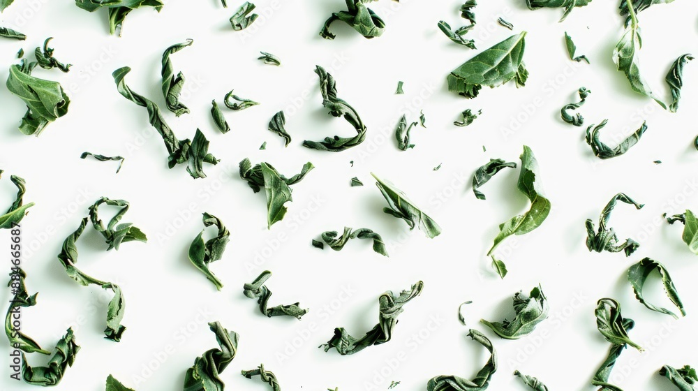 A bunch of green leaves arranged on a white surface A bunch of green leaves arranged on a white surface