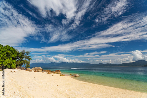 Picturesque tropical golden Nudey Beach with turquoise water on Fitzroy Island. It is a continental island southeast of Cairns, Queensland, Australia. photo