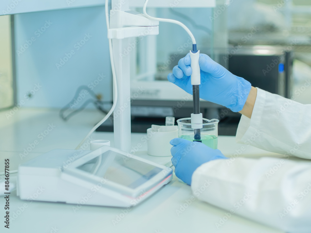 The scientist work at the chemical solution with pH meter The scientist work at the chemical solution with pH meter