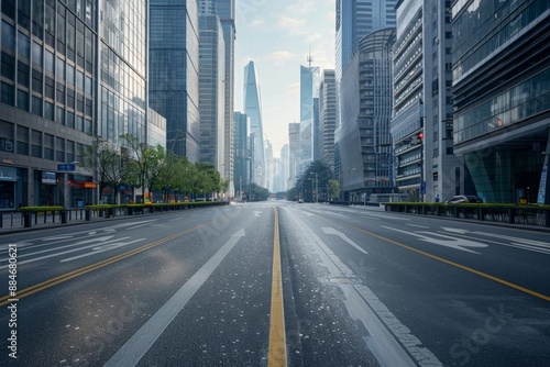 An empty street in the center of the frame, surrounded by skyscraper buildings