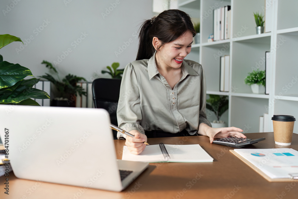 Young Professional Woman Working from Home Office with Laptop and Calculator, Smiling and Engaged in Remote Work Young Professional Woman Working from Home Office with Laptop and Calculator, Smiling and Engaged in Remote Work