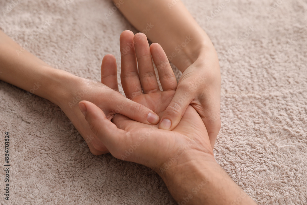 Man receiving hand massage on soft towel, closeup Man receiving hand massage on soft towel, closeup