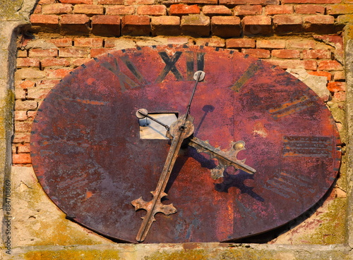 Old rusty clock of the old catholic church in Jasa Tomic. photo