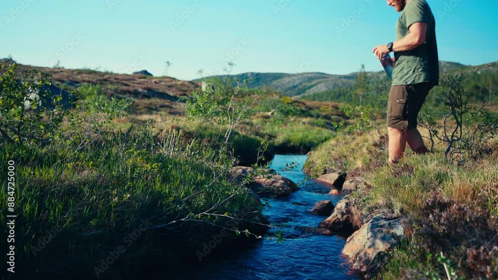 Male Hiker Drinking Water From The Creek In Indre Fosen, Norway - Wide Shot Male Hiker Drinking Water From The Creek In Indre Fosen, Norway - Wide Shot
